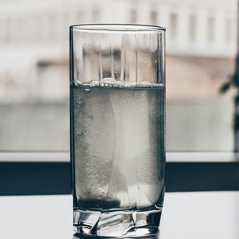 glass of water near office window glass of water near office window